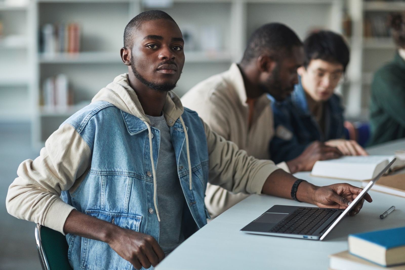 College students studying together with laptops and notebooks